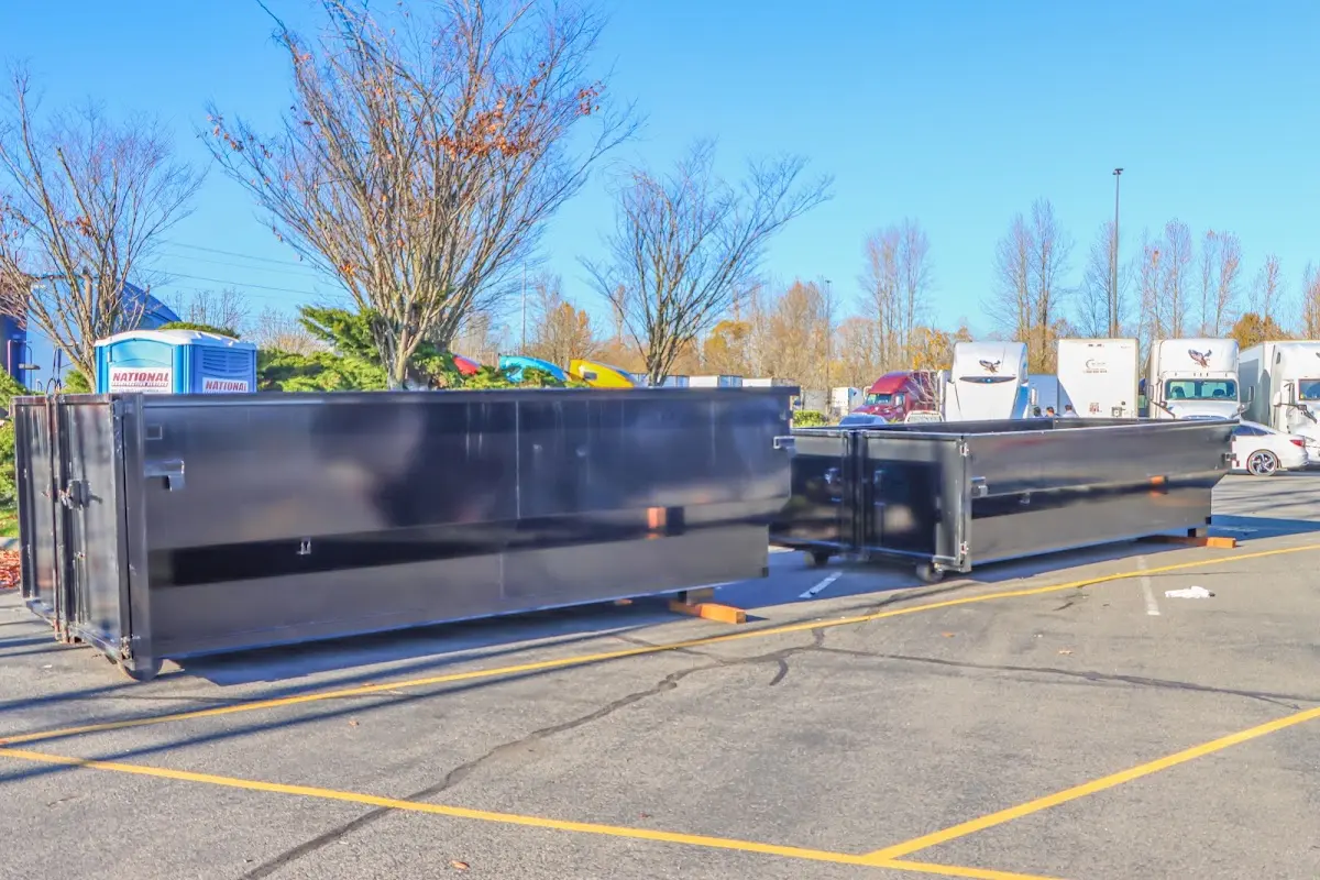 Professional dumpster rental service with roll-off container on residential driveway in Arkadelphia